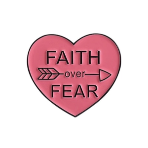 Pink heart enamel pin with Faith over Fear quote and arrow design on white background