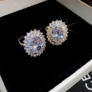 Macro detail of oval zircon halo rings in a premium black velvet jewelry box