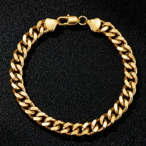 Chunky gold-plated stainless steel Cuban link bracelet with a heart lobster clasp design