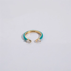 Detailed top view of a gold open ring with teal enamel and pear-cut zircon stones
