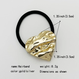 Close-up of black elastic hair tie with a 3.5cm hammered gold heart alloy pendant