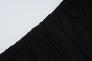 Detailed macro view of black mesh fabric with elegant pleated textures for stylish dresses