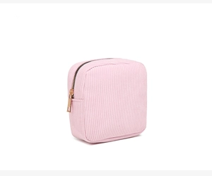 Close-up of pink corduroy makeup bag with premium gold zipper and soft texture detail