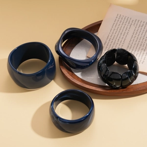 Set of four irregular geometric resin bangles in deep blue and black marble style