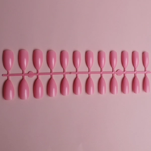Flat lay of 24 pieces pink glossy almond-shaped press-on nails on a plastic holder