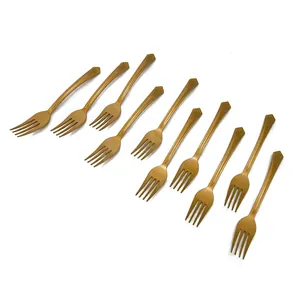 Detailed view of ten disposable golden plastic forks with decorative shell-pattern handles