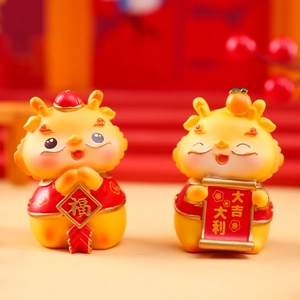 Close-up of yellow resin dragon figurines with Fortune charms for Lunar New Year decor
