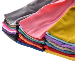 Close-up of stacked colorful knitted sports headbands showing soft texture and elastic fabric