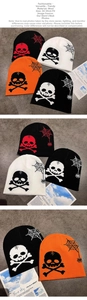 Detail of knitted skull and spider web jacquard patterns on bone beanies