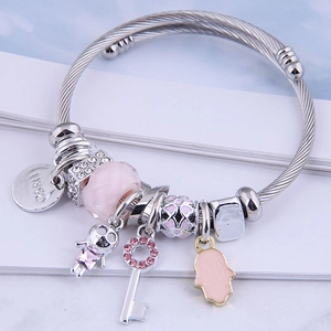Adjustable silver wire bangle with pink beads, Fatima hand, and key charm charms