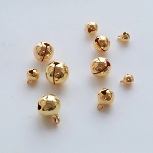 Close-up of assorted gold plated copper bells for DIY jewelry and Christmas decoration