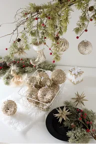 Detail of champagne gold Christmas ornaments with glitter finish and star pendants