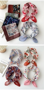 Detail shot of cotton-linen scarves featuring diverse floral patterns and silky textures