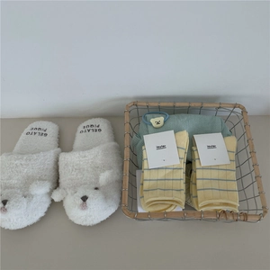 Cozy room scene with plush bear slippers and yellow striped cotton crew socks in a basket