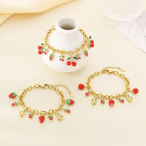 Gold stainless steel chain bracelet set featuring colorful zircon fruit charms like strawberry