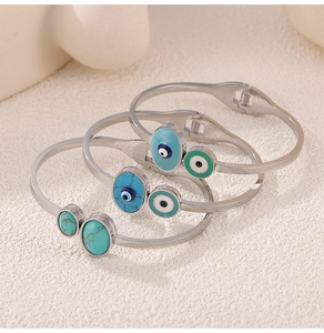 Detail of bohemian evil eye bracelets with turquoise inlay and silver finish stainless steel
