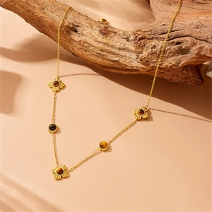 Macro detail of gold-plated tiger eye flower pendant necklace on natural wood