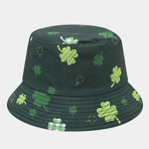 Detail shot of green bucket hat showing clover pattern and fine cotton stitching texture