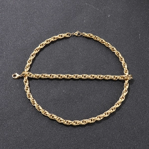 Detailed view of two gold titanium steel box chains on a textured black background