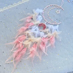 Pink and white moon dream catcher with real feathers and tree of life on starry background