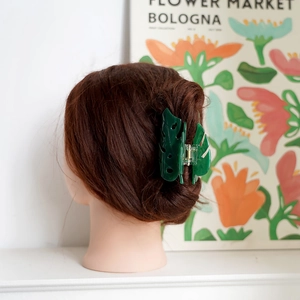 Green Monstera leaf hair claw clip made of acetate for elegant hairstyling on curly hair