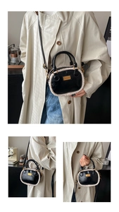 Detail of black leather Boston bag featuring white faux fur trim and gold metal hardware