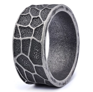 Retro punk style wide stainless steel ring with rustic cracked texture on white background