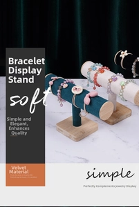 Detail of velvet T-bar jewelry stands with bamboo bases on a marble surface