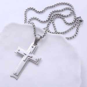 Three-layer silver stainless steel cross pendant necklace on white ceramic tray