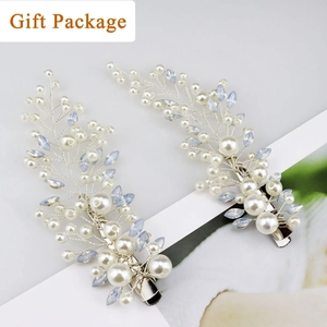Detailed view of silver hair clips with white pearls and blue crystals for weddings