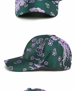 Detailed view of green jacquard baseball cap with purple floral and phoenix embroidery