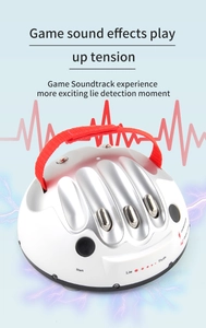 Detail view of electronic lie detector toy with hand strap and LED truth indicator lights