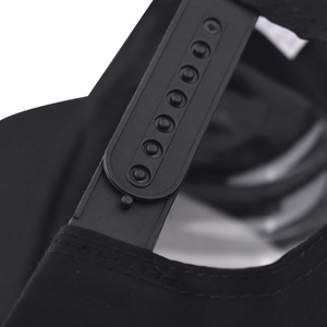 Macro view of adjustable black plastic snapback closure on a six-panel baseball cap