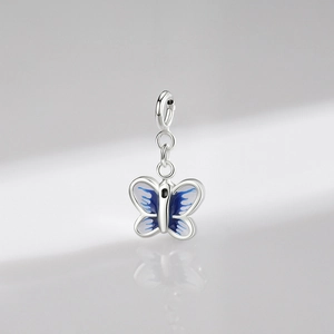 925 sterling silver butterfly pendant with blue enamel and clasp on reflective surface