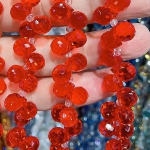 Macro detail of red faceted glass strawberry beads for DIY jewelry making and crafts