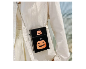 Detail of Halloween crossbody bag featuring orange pumpkin prints and silver chain strap