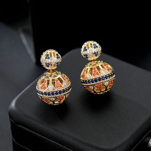 Detailed macro view of retro hollow double ball earrings with colorful micro-set zircons