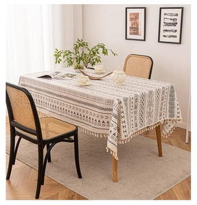 Detail of bohemian cotton linen tablecloth with black geometric patterns and fringes