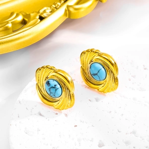 Detail shot of vintage gold oval earrings with turquoise inlay on stone base