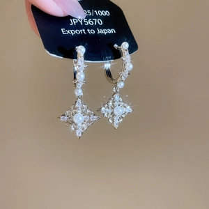 Detailed macro shot of 18K silver plated zircon diamond rhombus pearl drop earrings
