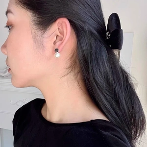 French style minimalist S925 silver pearl drop earrings for women on a model