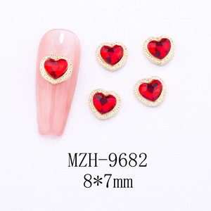 Detail of red heart nail charms with gold textured edges and 8x7mm dimensions