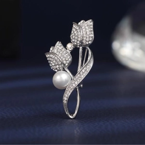 Elegant silver tulip brooch with sparkling rhinestones and a white pearl accent