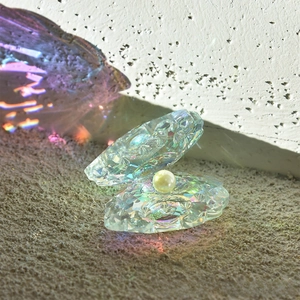 Macro shot of iridescent aurora crystal shell with pearl detail on a textured surface