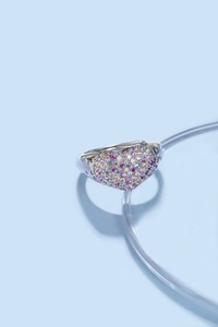 Macro shot of silver heart ring with colorful pink and purple cubic zirconia stones