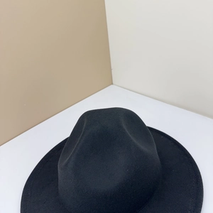 Top view of a classic black wool fedora hat with a stylish dented crown and wide brim