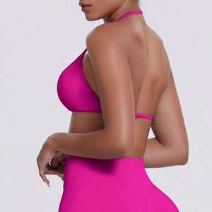 Detail of rose pink ribbed sports bra with halter neck and seamless textured fabric