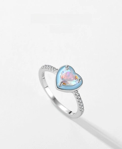 Detailed macro view of S925 sterling silver heart ring with opal and enamel inlay