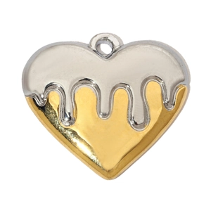 Macro view of two-tone fluid metal heart pendant with polished silver and gold finish