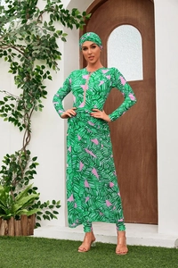 Detailed view of women's long-sleeve burkini swimsuit with tropical green leaf print